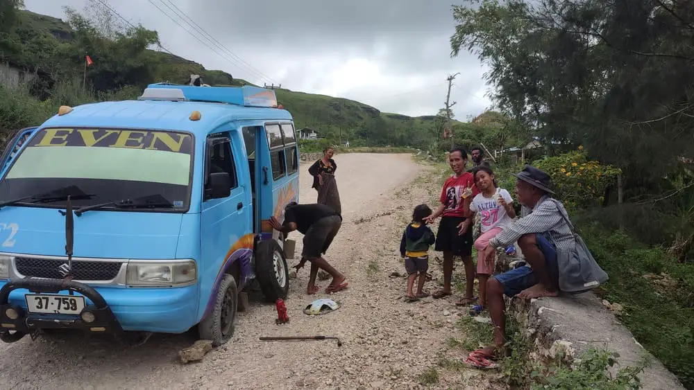 Our minibus from Baucau to Viqueque got a flat tire and the driver is fixing it.
