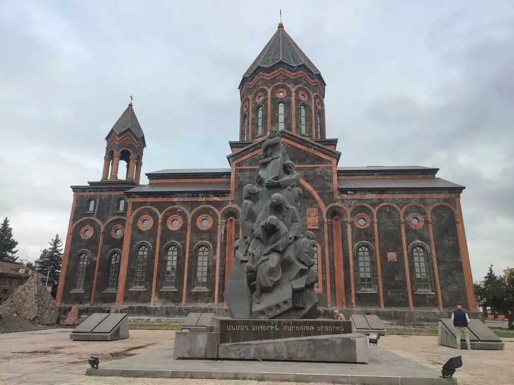 Gyumri Cathedral with the small statue in front of it.