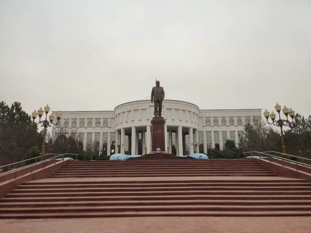 Islam Karimov Museum with a statue of the late Uzbek leader in front.