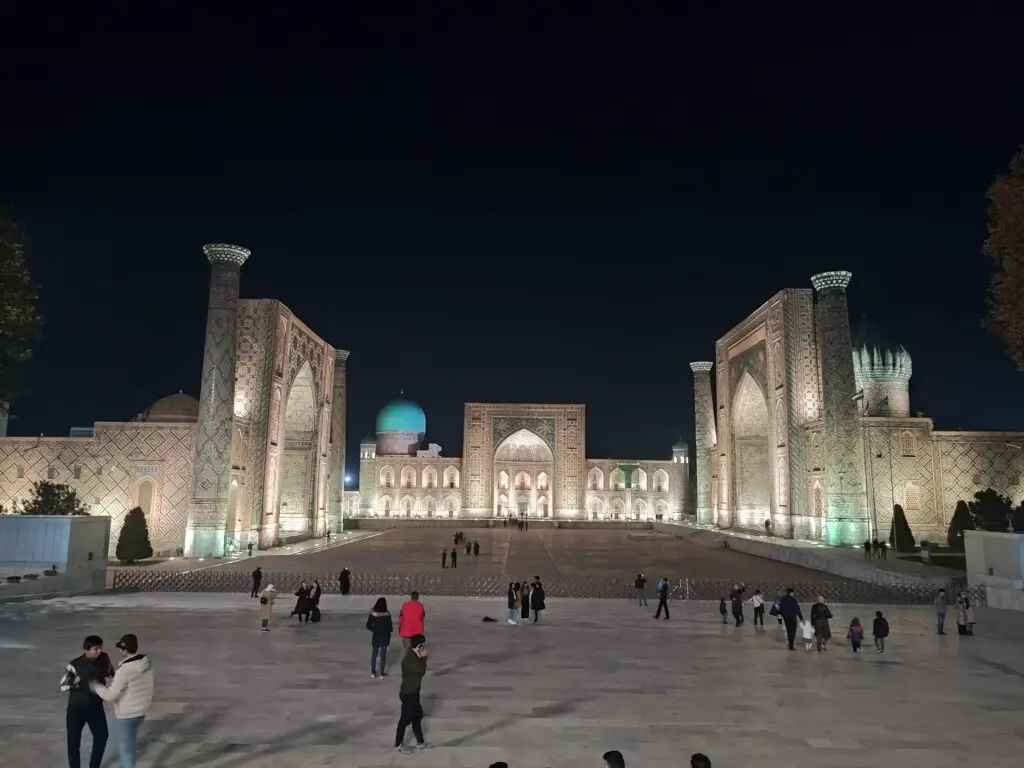 Registan Square with its illuminated madrasahs at night