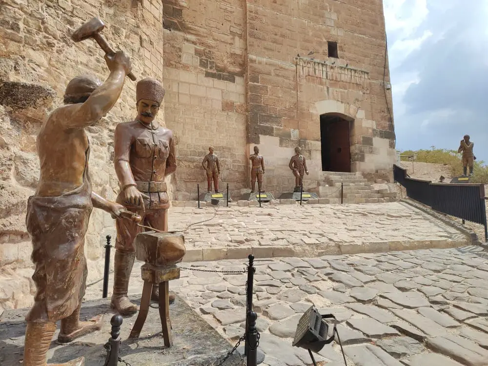 A coppersmithing statue in front of Gaziantep Castle