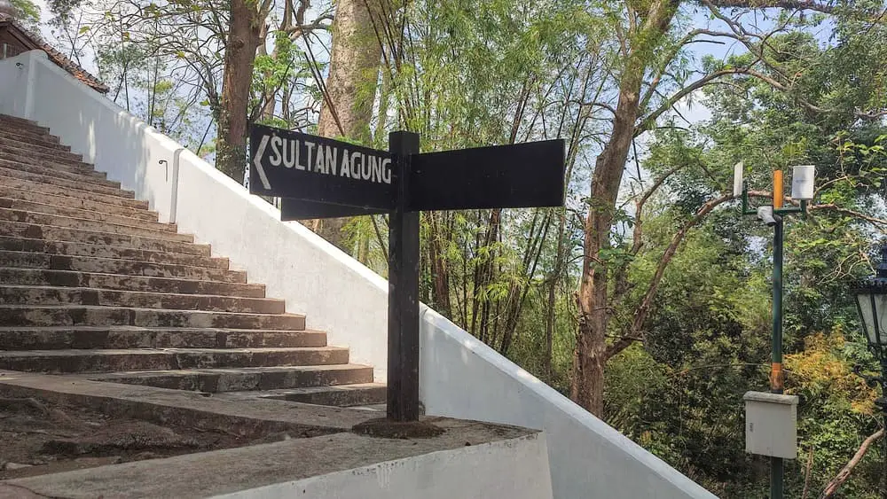A sign showing the direction of the Tomb of Sultan Agung