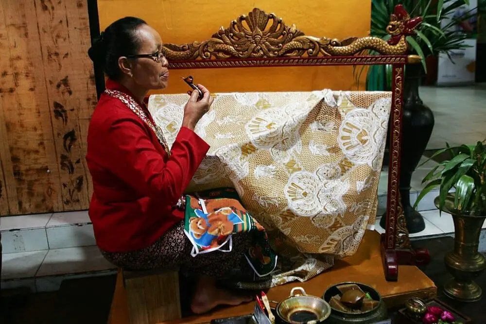 An old Javanese lady working on a batik