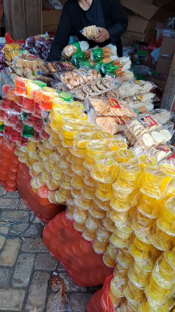 Columns of packaged carica for sale at a market