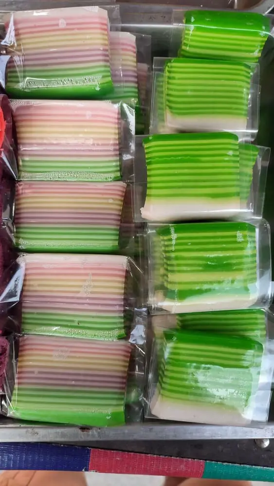 Layered colorful Kue Lapis ordered in a tray and individually packed