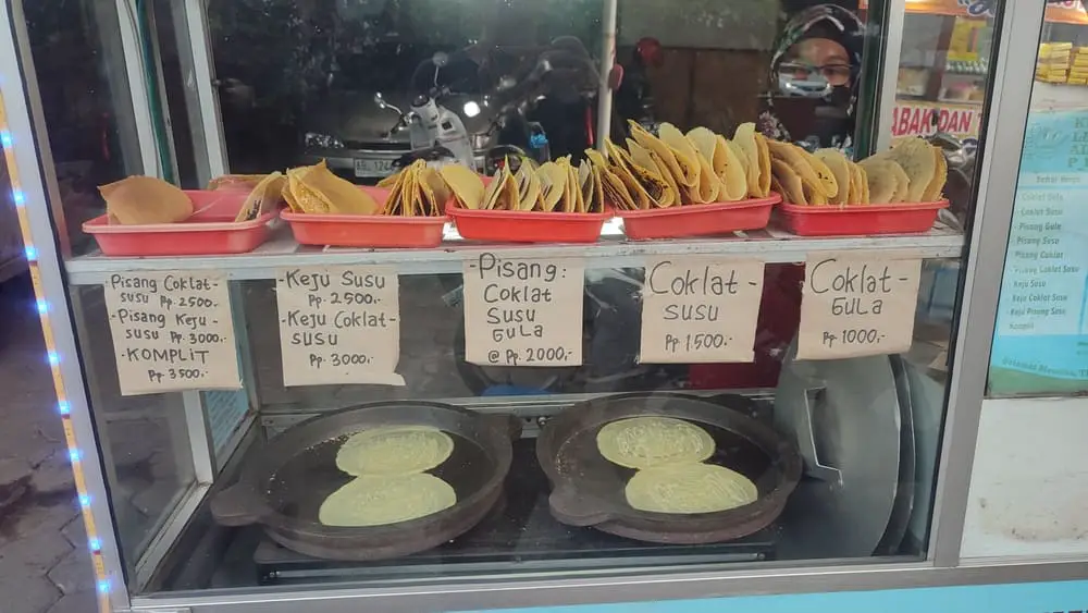 A street vendor's cart with different flavours of leker