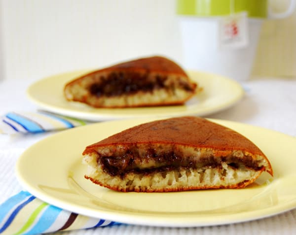 Two pieces of martabak manis on plates