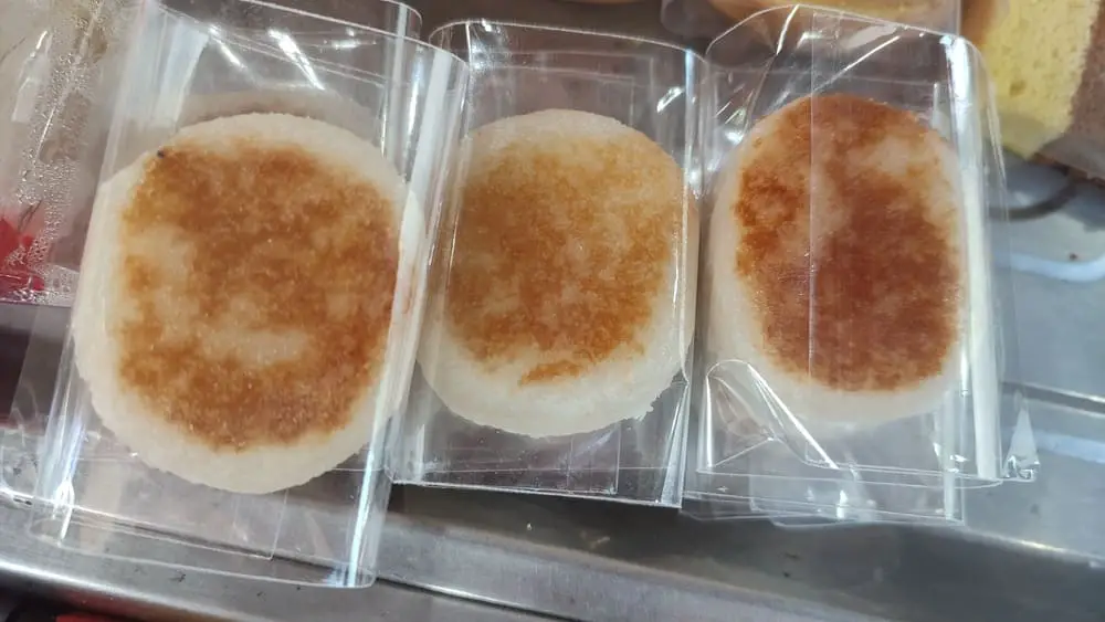 Three individually packaged wingko dessert cakes