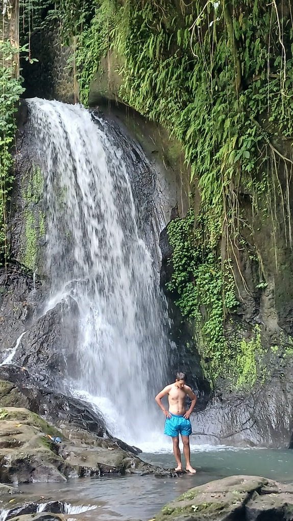Simon in front of heavy flow Taman Sari waterfall in Bali