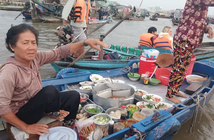 Ladies selling noodles soup on a boat in Cai Rang floating market in Can Tho, Vietnam