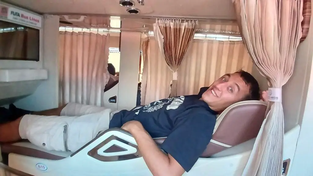 Simon lying inside a sleeper bus