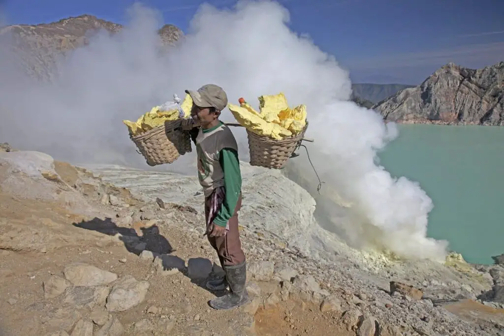 A sulfur miner carrying over 50 kg of sulfur at Kawah Ijen