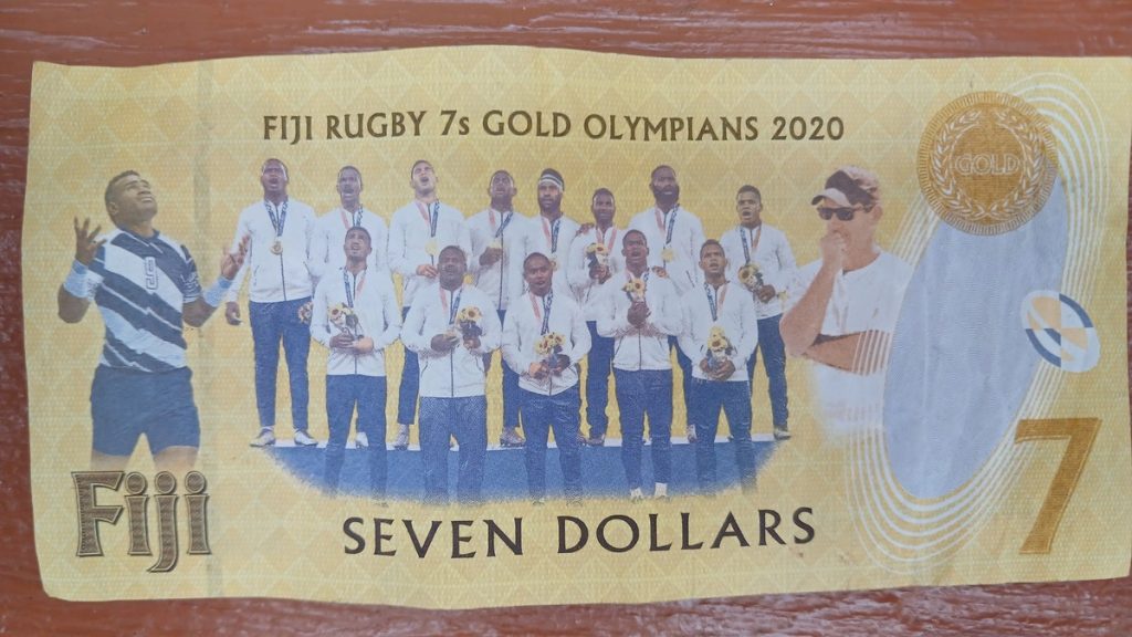 7 Fiji dollars banknote with rugby players and coaches. It's used as official money in Fiji