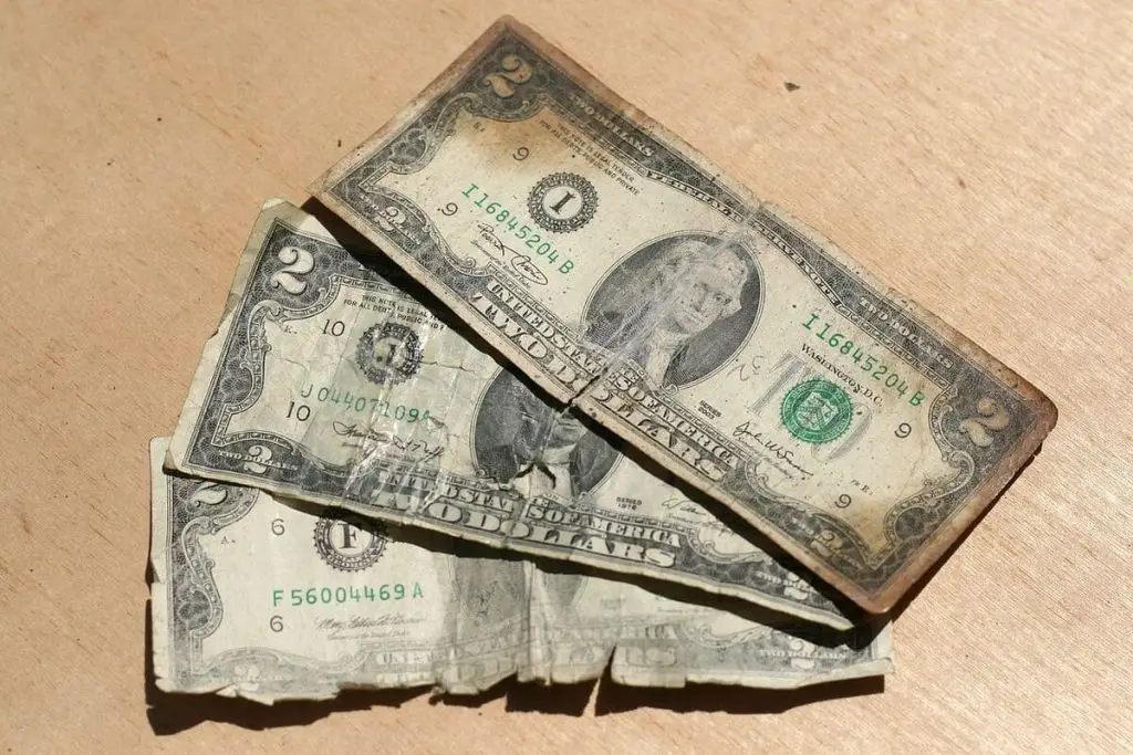 3 old, used and damaged 2$ notes