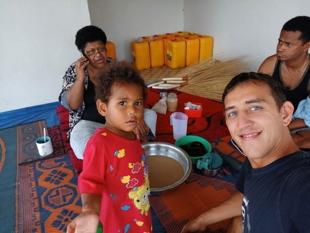 Simon taking a selfie with Fijian locals and sharing a bowl of kava