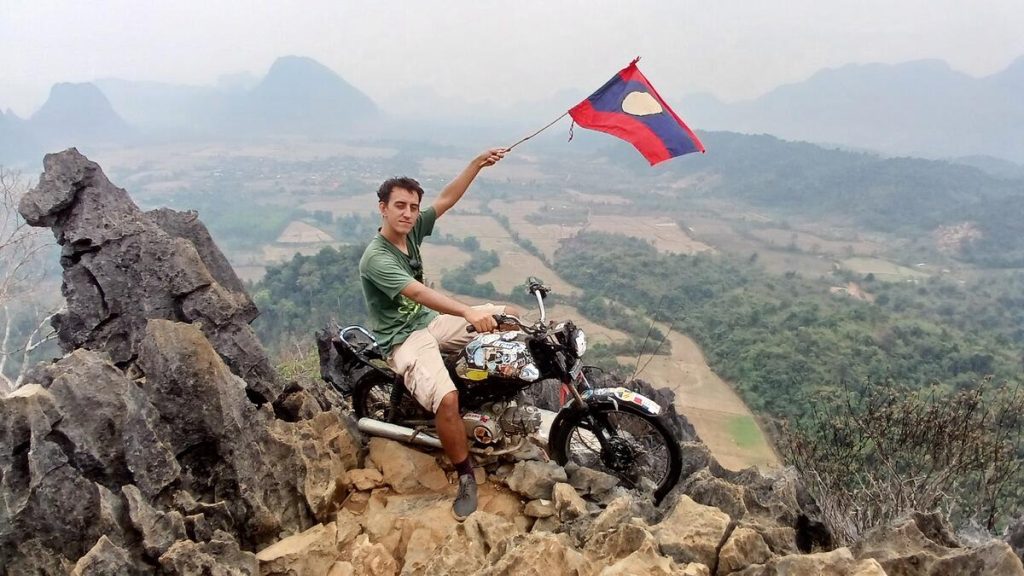 Simon "riding" the motorcycle on top of Nam Xay Viewpoint