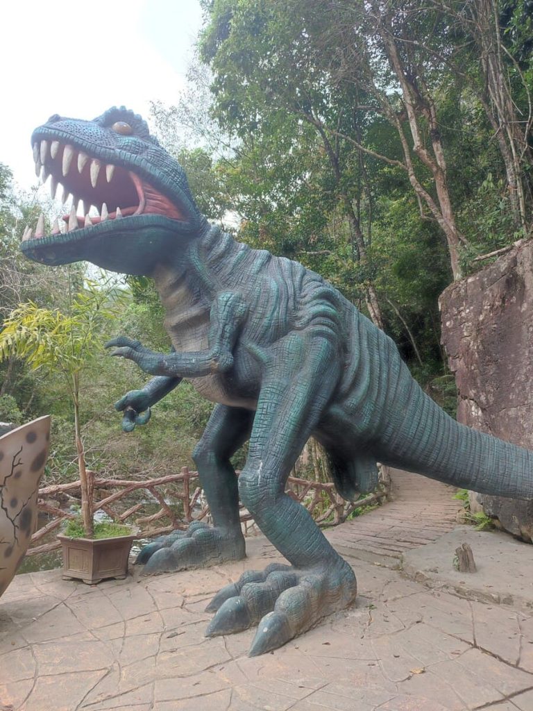 A statue of a dinosaur with testacles