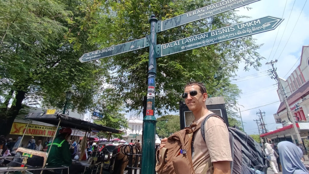 Simon carrying to backpacks in Yogyakarta, ready to explore the real Javanese culture and life!
