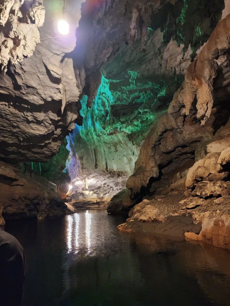 a cave with water and lights