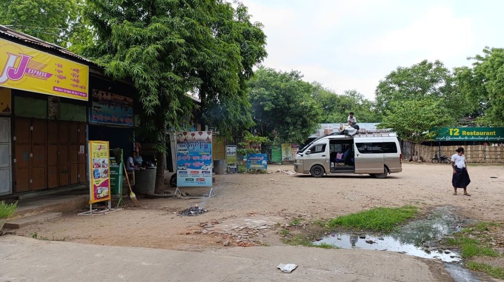 A minibus parked at an unpaved station near Bagan in Myanmar