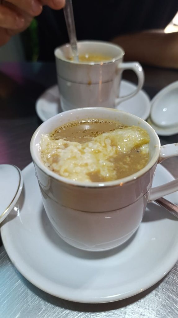 a cup of myanmar tea with milk curd