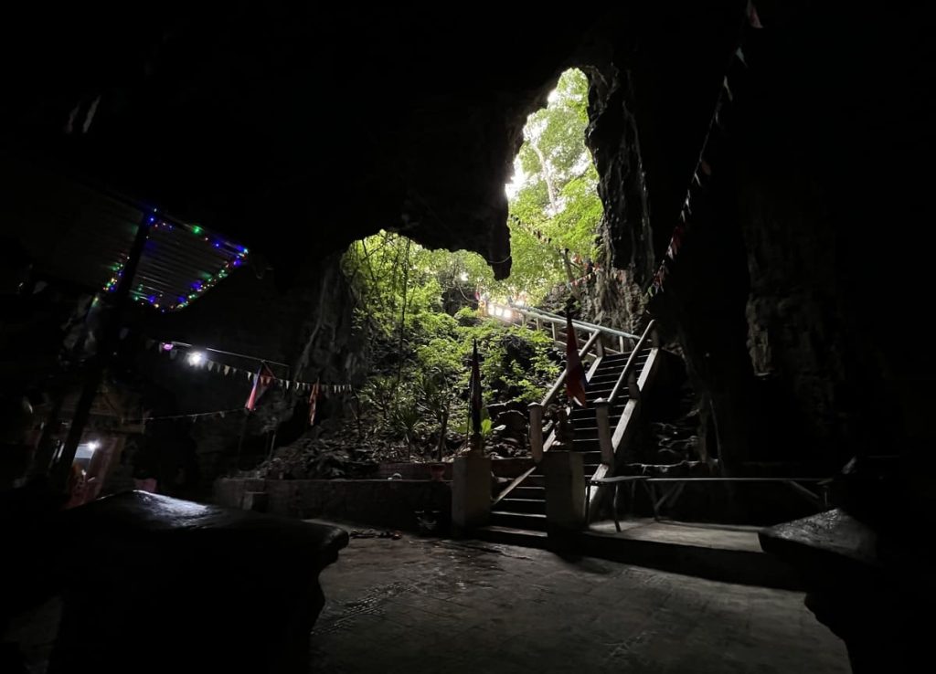 Inside of the Killing Cave with camera pointing towards the staircase leading outside