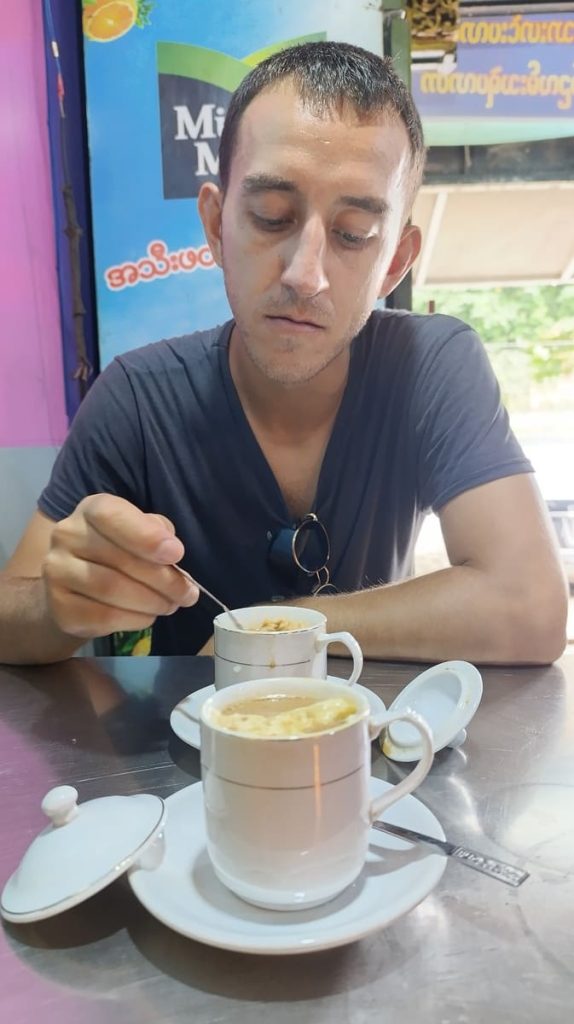 2 cups of burmese tea with milk curd and Simon stirring one