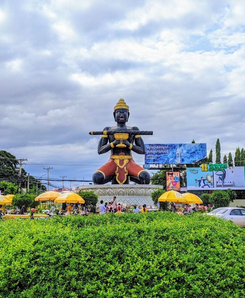 Lan Chov Khorko Miteanh - a statue of a black deity holding a goblet and balancing a staff.