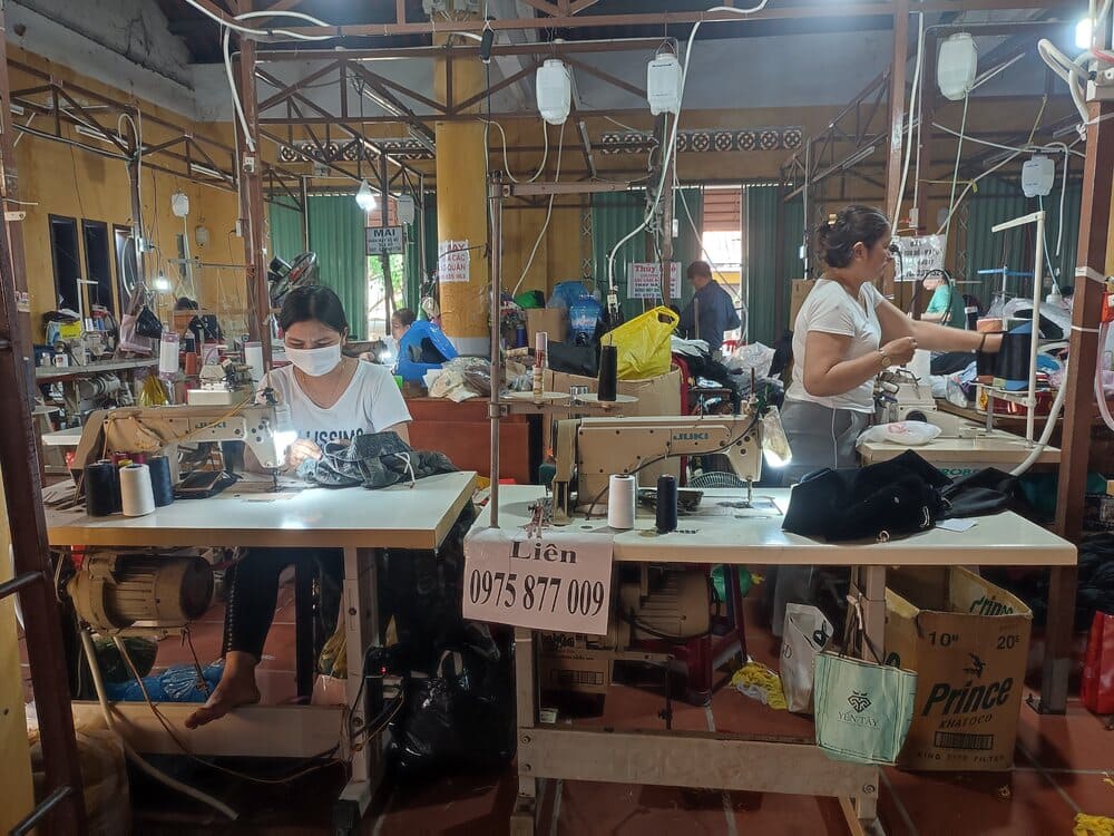 Inside a tailor shop in Hoi An with tailor girls working. 