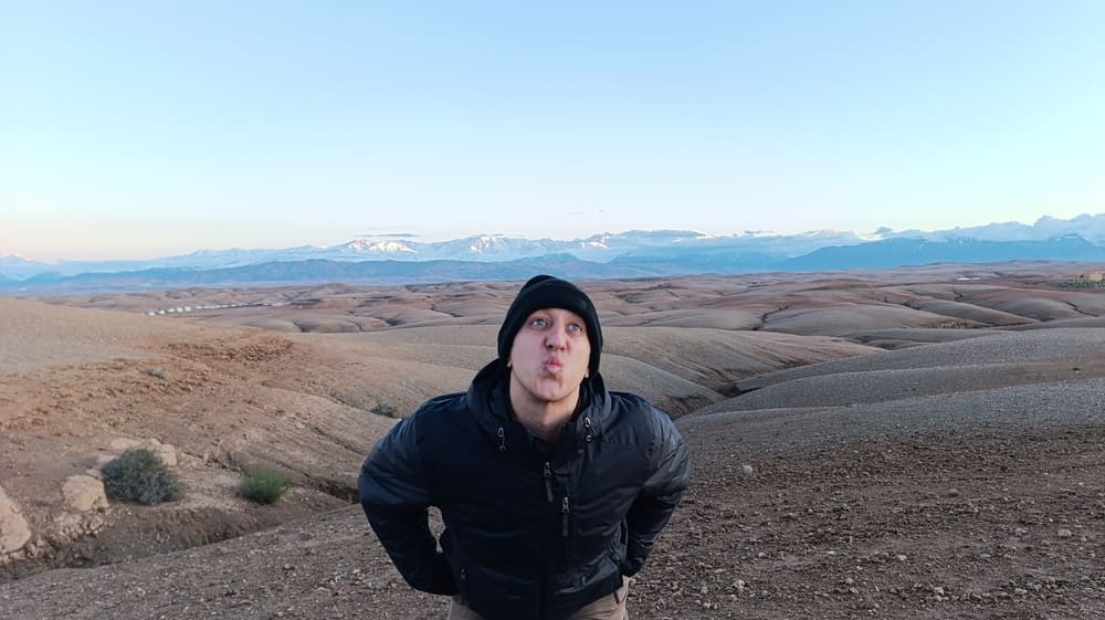 Simon in Agafay Desert with the Atlas Mountains in the backdrop